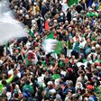 Algerian protesters wave national flags during an anti-government demonstration in the capital Algiers