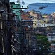 A police helicopter overflies the Favela da Mare shantytown complex in Rio de Janeiro in March 2014 -- the use of helicopters in police raids has increased in recent months