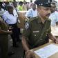 Police and electoral officials collect ballot papers ahead of Saturday's polls