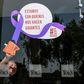 A woman cleans the glass door of a Mexico City restaurant with a sign reading 'We stand with those who make us giants' during Monday's 'A Day Without Us' protest