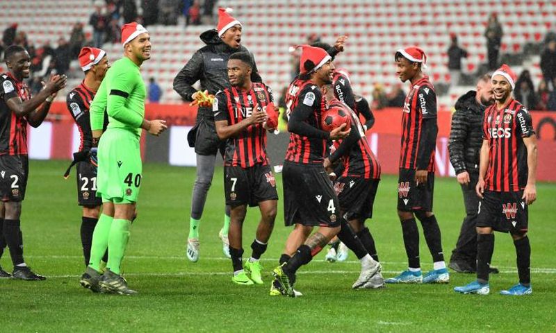 Nice celebrate their win with the offending festive hats