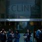People walk outside the Hospital Clinic in Barcelona on February 25, 2020 where a woman was hospitalised in a suspected case of coronavirus