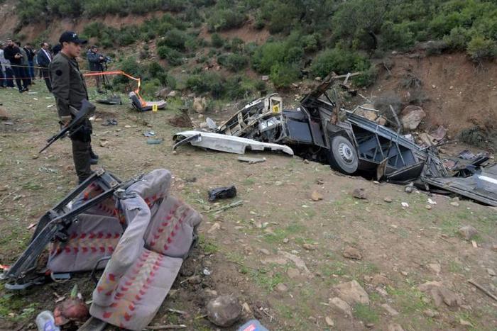 Tunisian security forces check the remains of a bus that plunged over a cliff into a ravine, in Ain Snoussi in northern Tunisia on December 1, 2019 killing 24 people