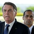 Brazilian President Jair Bolsonaro, pictured on March 20, has sparked outrage among critics with a national address condemning "scorched-earth" containment measures such as closing businesses and confining people