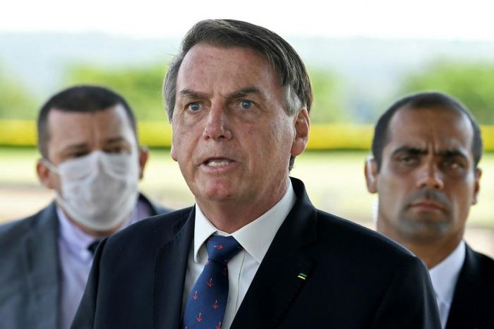 Brazilian President Jair Bolsonaro, pictured on March 20, has sparked outrage among critics with a national address condemning "scorched-earth" containment measures such as closing businesses and confining people