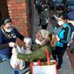 Food and packages of donated goods are distributed to people at a food bank in Chelsea, Massachusetts