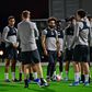 Mohamed Salah (C) and his Liverpool teammates train in Doha on Monday as manager Jurgen Klopp watches on