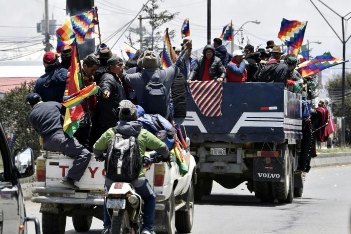 Indigenous supporters of Bolivian ex-president Evo Morales travel from El Alto to La Paz to protest against the interim government on November 15, 2019