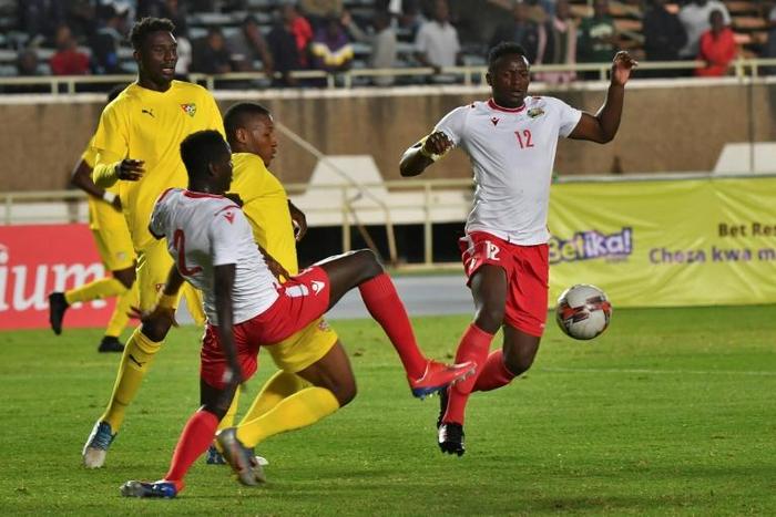 Peniel Mlapa (L) and Kodjo Fo-Doh Laba of Togo and Victor Wanyama (R) and Stanley Okumu of Kenya seek possession during a drawn Cup of Nations qualifier