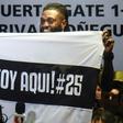 Togo forward Emmanuel Adebayor holds up a message to his new fans at Paraguay champions Olimpia on his arrival in Asuncion