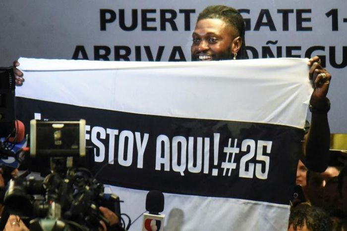 Togo forward Emmanuel Adebayor holds up a message to his new fans at Paraguay champions Olimpia on his arrival in Asuncion