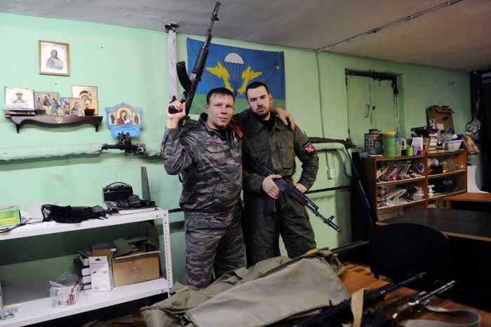 Members of the Russian Imperial Movement who are volunteers of the self-declared Donetsk People's Republic pose with weapon simulators at a training base in Saint Petersburg in 2015