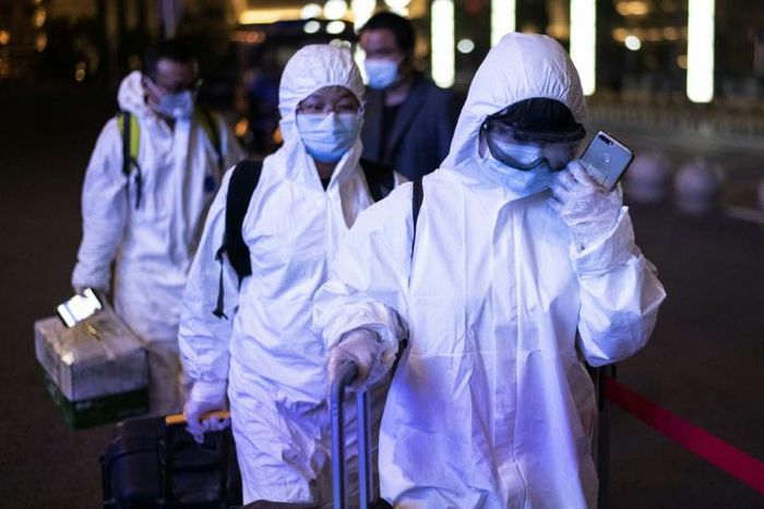 Many passengers wore hazmat suits as they arrived at Wuhan's Wuchang rail station to board some of the first trains to leave the Chinese city in more than two months