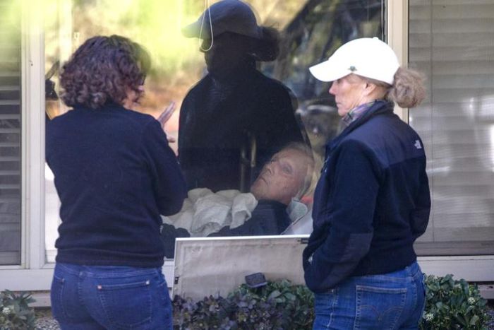 Seri Sedlacek (L) and her sister Susan Sedlacek visit their father, Chuck Sedlacek, a patient at the Life Care Center, on March 18, 2020 in Kirkland, Washington