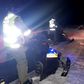 Police use snowmoblies during a search and rescue operations after a Canadian guide died and five French tourists went missing when their snowmobiles plunged through ice into the freezing water
