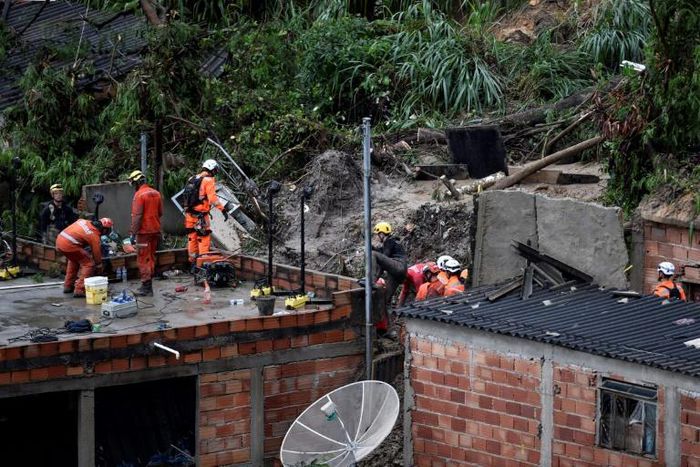 Rescue workers looked for victims after two houses collapsed during record rainfall in southeastern Brazil