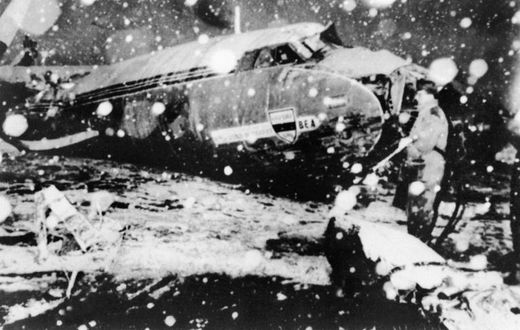 A rescue worker stands next to the debris of the plane carrying Manchester United players that crashed at Munich airport in 1958