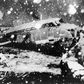 A rescue worker stands next to the debris of the plane carrying Manchester United players that crashed at Munich airport in 1958