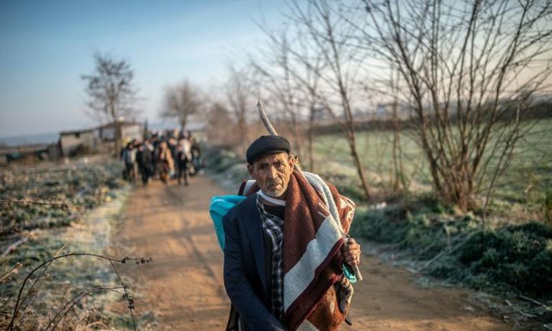 A migrant walks towards the Greek border on Sunday but he can't expect a warm welcome
