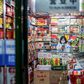 A vendor wearing a protective facemask waits for customers at a shop in Beijing
