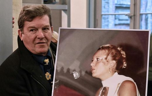 Jacky Kulik holds a portrait of his daughter Elodie who was kidnapped, raped, strangled and her corpse then burned in northern France in January 2002