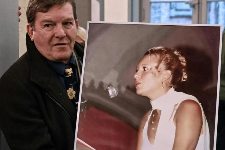Jacky Kulik holds a portrait of his daughter Elodie who was kidnapped, raped, strangled and her corpse then burned in northern France in January 2002