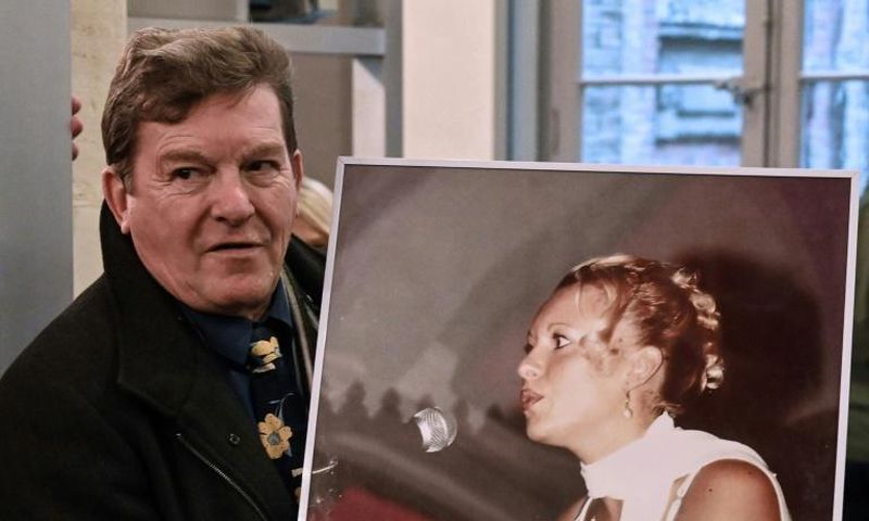 Jacky Kulik holds a portrait of his daughter Elodie who was kidnapped, raped, strangled and her corpse then burned in northern France in January 2002