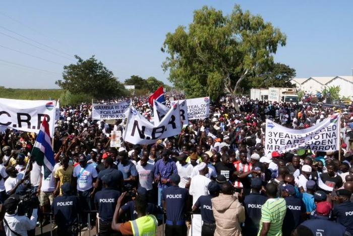 Protesters take part in a demonstration against Gambian President Adama Barrow, calling for him to keep his pledge to quit after three years in office