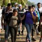 A Central American migrant family is escorted by members of the Mexican National Guard and officers of the Migration Institute after being detained crossing the Suchiate River, in Mexico