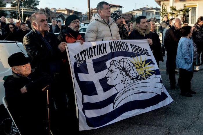 Inhabitants hold a banner reading "Patriotic Movement of Pieria" as they gather outside the town hall during a protest against the creation of a migrants' hosting centre, in Makrigialos, a beachfront tourist village, some 460km north of Athens.