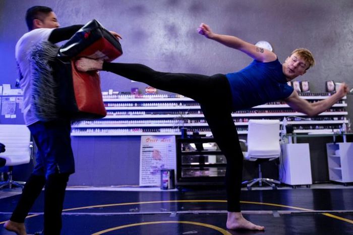 Vu Pham, a Vietnamese immigrant who fell prey to drugs, teaches mixed martial arts to a youth in Defiance, Ohio in a project at his nail salon to keep young people out of trouble