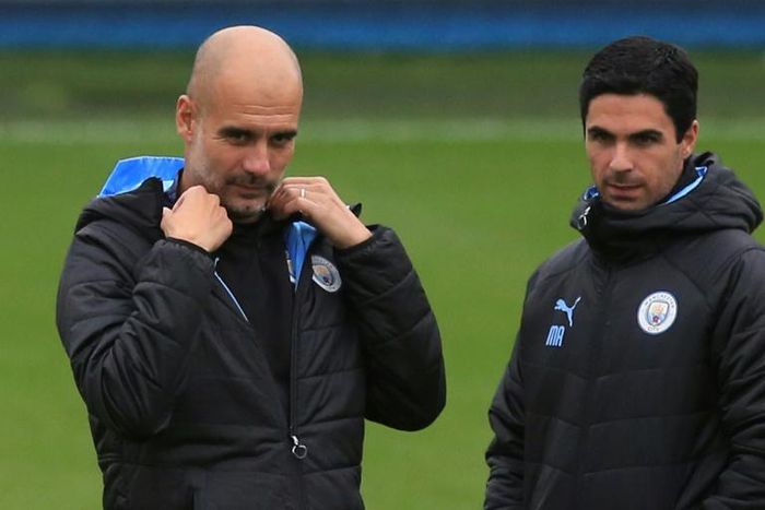Manchester City manager Pep Guardiola (L) and his former assistant Mikel Arteta, who is the new Arsenal boss
