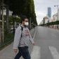 A man wears a face mask to protect against the COVID-19 disease in the Tunisian capital Tunis, where a curfew has already been imposed to stem the spread of the virus
