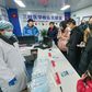 Experts say China is taking a starkly different approach to handling a new virus outbreak compared with the 2002-03 SARS crisis
