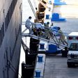 Medics transfer a patient on a stretcher from Holland America's cruise ship Zaandam after it docked at Port Everglades in Fort Lauderdale, Florida