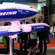 Visitors look at Boeing 787 and 777 models on display at the Singapore Airshow