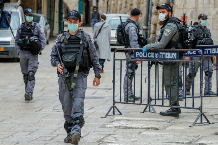 Israeli security forces, wearing protective masks as a precaution during the COVID-19 coronavirus pandemic, stand guard in Jerusalem's old city