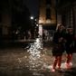 People cross a flooded street during an exceptional "acqua alta" on November 12 in Venice