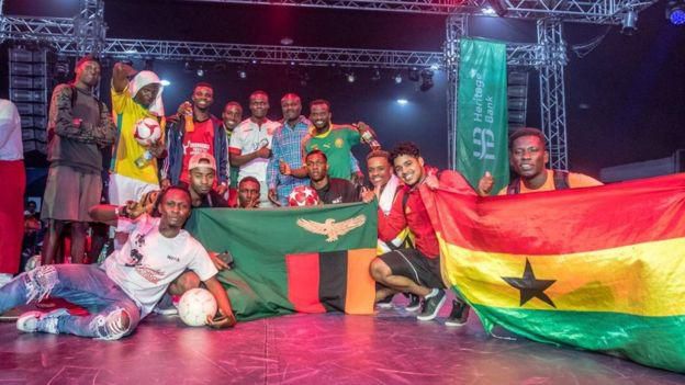 Lucky Sarpong (far right) holding a Ghana flag during the 2019 African Freestyle Football Championship