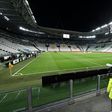 A steward looks at the empty Juventus stadium before the Serie A match against Inter Milan behind closed doors on March 8, 2020.