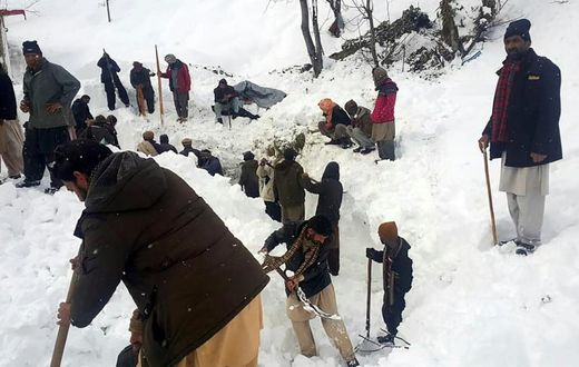 Local residents search for victims of an avalanche that hit the  Neelum Valley in Pakistan-administered Kashmir