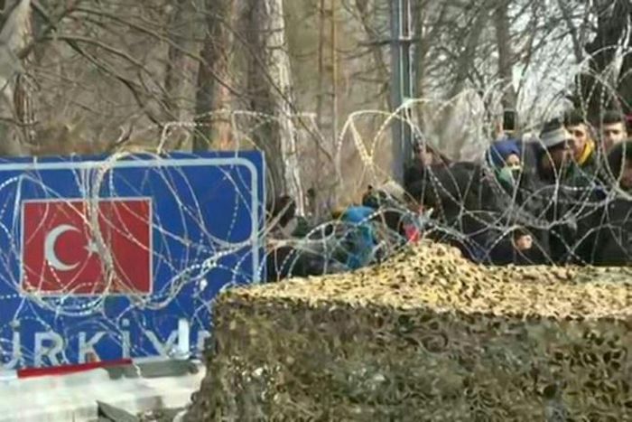 IMAGESMigrants hoping to cross over to Greece wait behing barbed wires on the Turkish side of the border, as armed forces prepare to stop them from coming in.