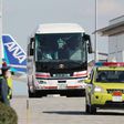 Japanese evacuees are transported by bus after they arrived back in Tokyo from Wuhan