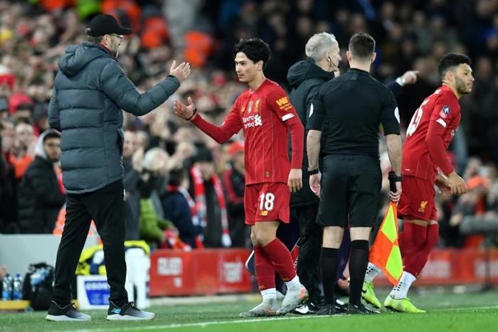 'Outstanding': Liverpool manager Jurgen Klopp  shakes hands with Takumi Minamino