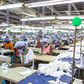 Workers sew personal protective equipment in Ghana, which has lifted a coronavirus lockdown that hit the poor hard