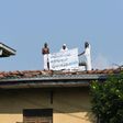 Inmates on the roof of Welikada prison in Sri Lanka display a banner calling for a pardon similar to that granted the murderer of a Swedish teen at the weekend