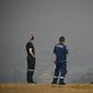 Paramedics take a break as they look out over a smokey haze which blankets Sydney.