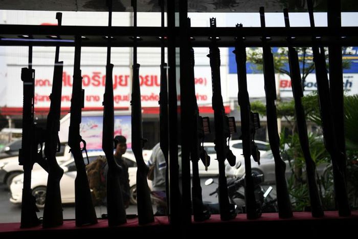 Guns are set up in a window display, located near the Terminal 21 shopping mall where a mass shooting took place in the northeastern Thai city of Nakhon Ratchasima