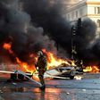 A policeman is seen near torched cars during a protest Sunday against Chilean President Sebastian Pinera's government in music festival venue Vina del Mar