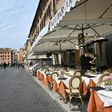 Many of Rome's outdoor restaurants and cafes were either closed Friday night or had free tables overseen by forlorn staff with little to do but chat